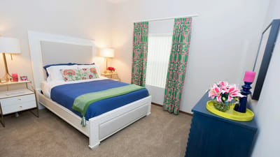 Brightly decorated private resident room with bedding