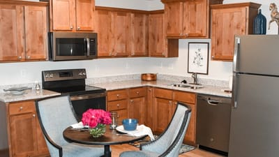 Modern kitchen interior with dining table and flowers