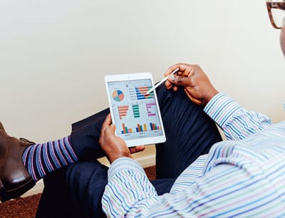 Person analyzing charts on a tablet