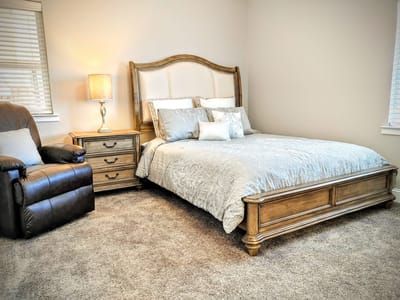 Cozy interior of a private resident room with a bed and chair