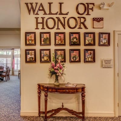Interior view of the Wall of Honor with photos and flags