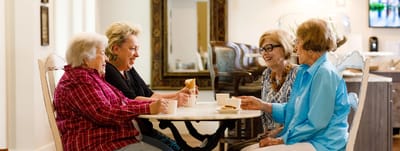 Residents enjoying snacks and conversation in a common area