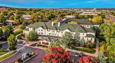 Aerial view of Woodlake Legacy Senior Living facility surrounded by trees