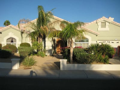 Exterior view of a senior living facility with lush landscaping