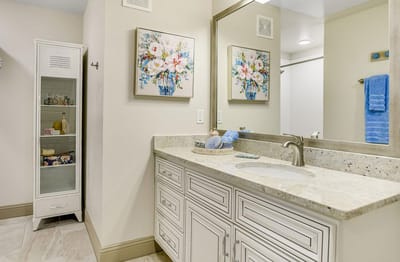 Bright bathroom with floral artwork and storage unit