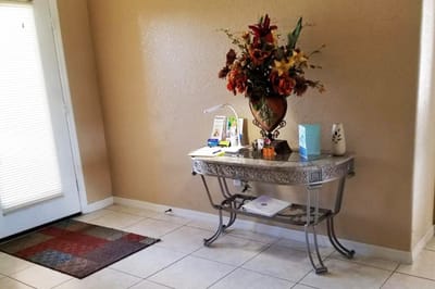 Decorative entryway table with a floral arrangement