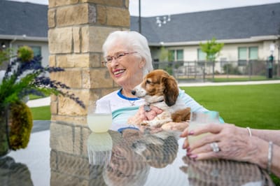 Resident enjoying time outdoors with a dog