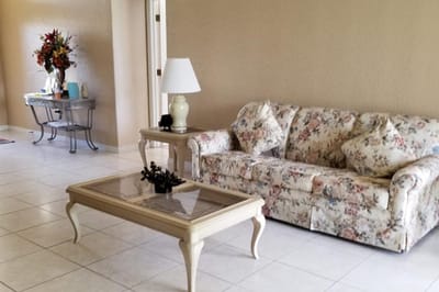 Bright and inviting common area with floral couch