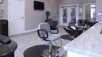 A hair salon area with styling chairs