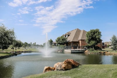 Outdoor view of a pond with a fountain and landscape