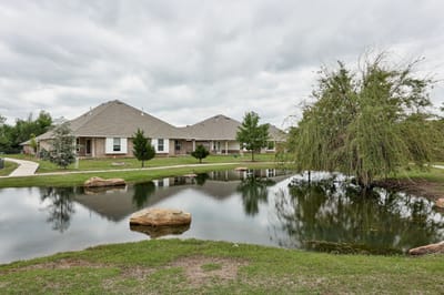Scenic view of a pond and residential buildings