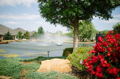 Beautiful pond with fountain and landscaping
