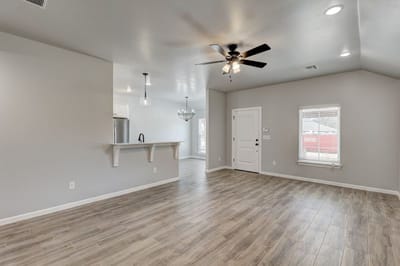 Bright interior space with wooden flooring and ceiling fan