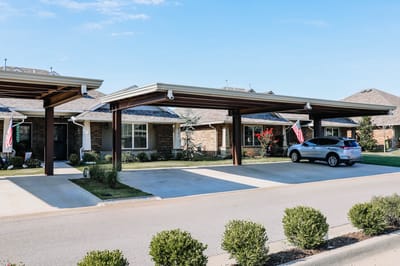 Covered parking spaces with car and landscaped area