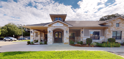 Entrance of Living Springs village with a stone facade.