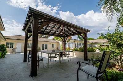 Outdoor gazebo area with tables and chairs