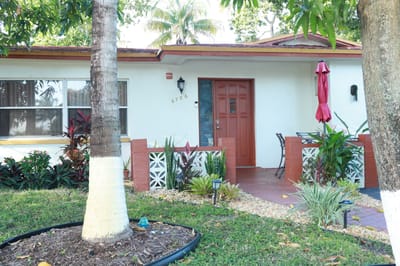 Exterior view of the facility entrance with tropical plants