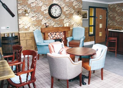 Cozy common area with chairs and a clock