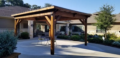 Outdoor pavilion with seating in a landscaped area