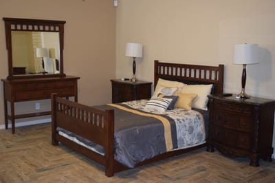 Well-furnished resident room with bed and mirror