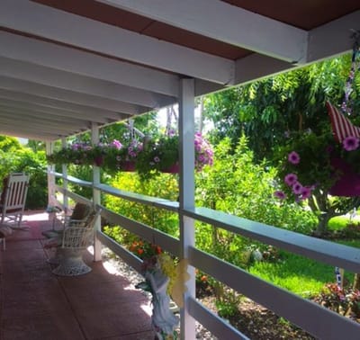 Outdoor space with hanging flower pots and seating