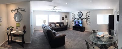 Bright common area with seating and a television