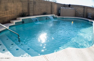 Outdoor pool area with water features