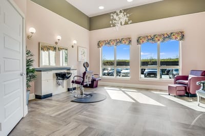 Bright salon area with chairs and large windows