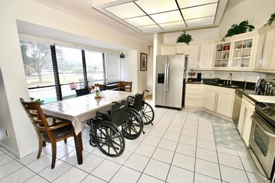 A spacious kitchen area with wheels near the dining table
