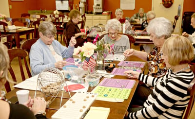 Residents participating in a bingo game in a common area