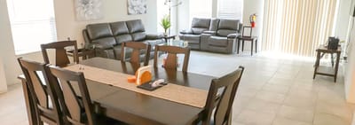 Bright and modern common area with seating and dining table