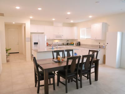 Bright kitchen with dining table and appliances
