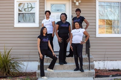 Staff members posing at the facility entrance
