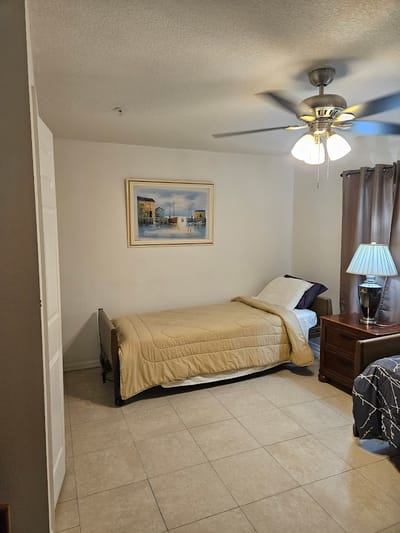 Private room with a bed and lamp