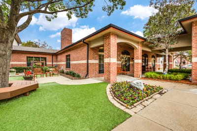 Exterior view of a senior living facility with landscaped grounds