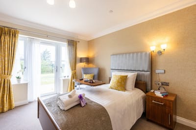Cozy resident room with natural light and floral decor