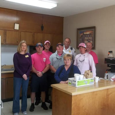 Group of staff and residents in a kitchen area