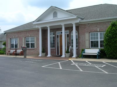 Exterior view of Carriage House Inn building entrance