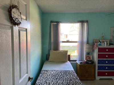 Cozy resident room with a bed and personal decorations
