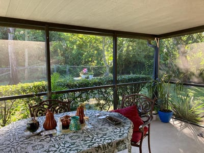 Screened patio with table and plants