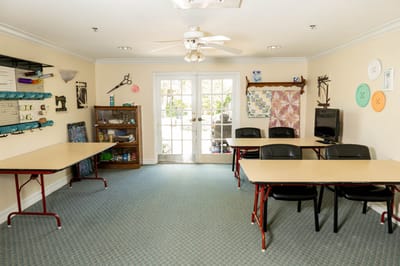 Bright activity room with tables and chairs