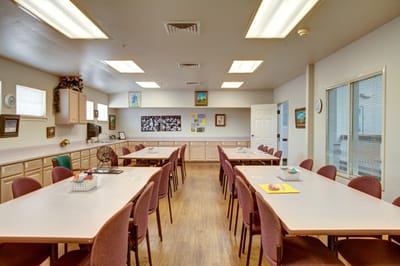 Bright activity room with tables and chairs