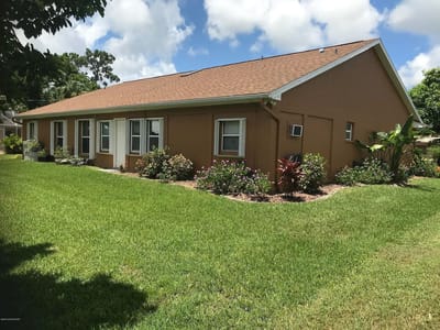 Exterior view of Donna's Assisted Living II with landscaped garden