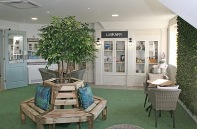 Cozy common area with library display and seating