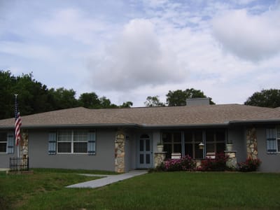 Exterior view of a senior living facility with American flag