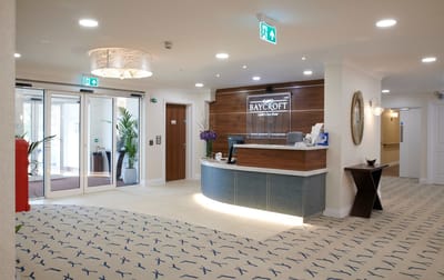 Elegant lobby of a senior care facility with reception.