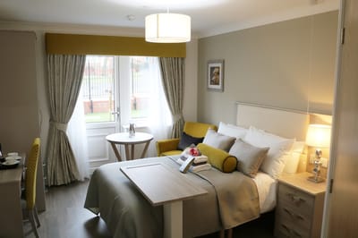 Private resident room with bed and seating area