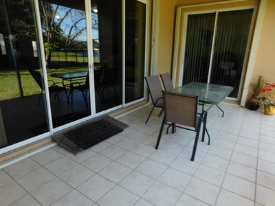 Patio area with seating near a grassy space
