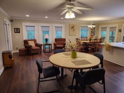Interior view of a common area with seating and dining tables