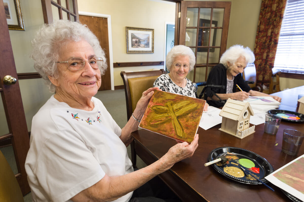 Residents engaging in an art activity in a common area
